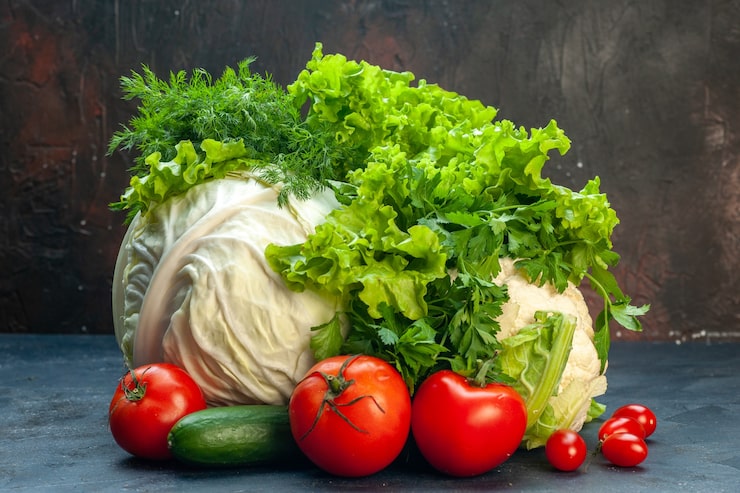 front-view-fresh-vegetables-cabbage-bell-peppers-lettuce-cauliflower-parsley-tomatoes-cucumber-dill-dark-surface_140725-62445